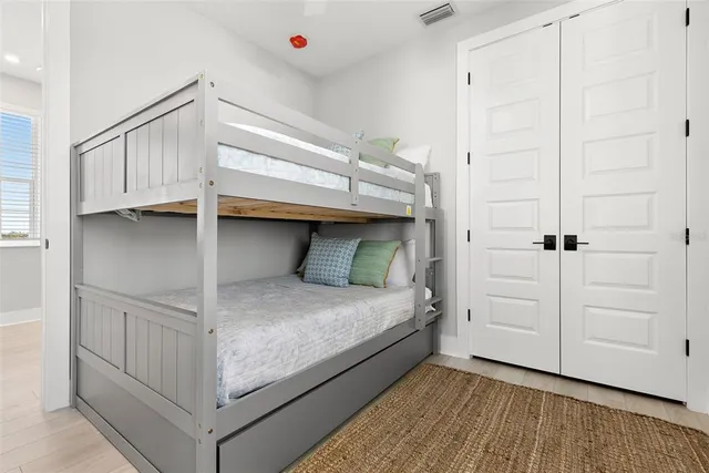 a bedroom with a bed and cabinets