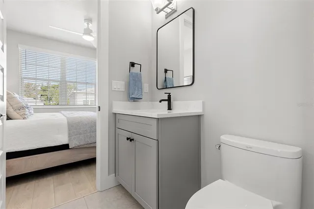 a en suite bathroom with a toilet sink and mirror