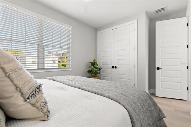 a bedroom with a bed and a couch