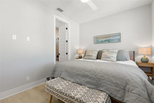 a bedroom with a bed and lamp