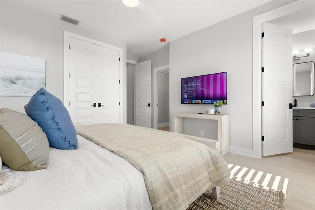 a bedroom with a bed and a flat screen tv