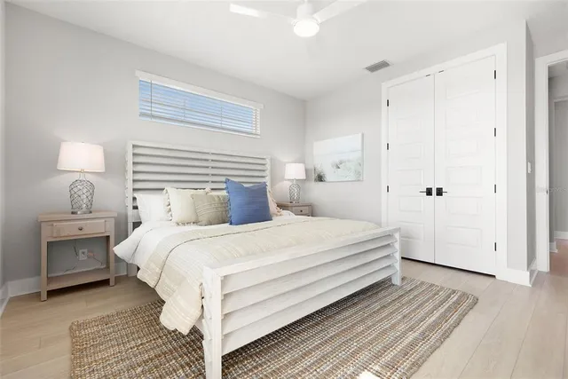 a bedroom with a bed and a night stand