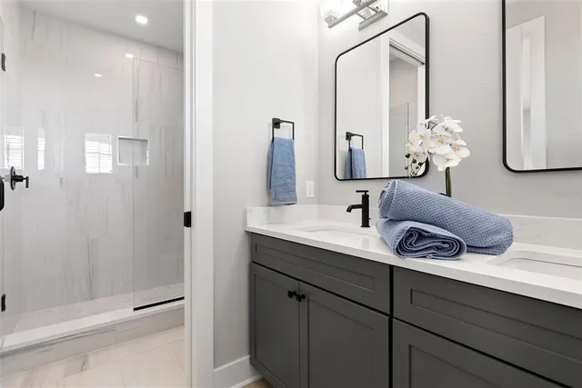 a bathroom with a double vanity sink and a mirror