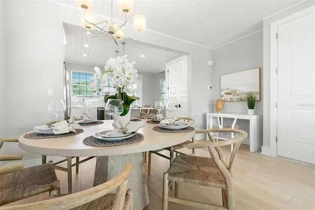 a view of a dining room with furniture and chandelier