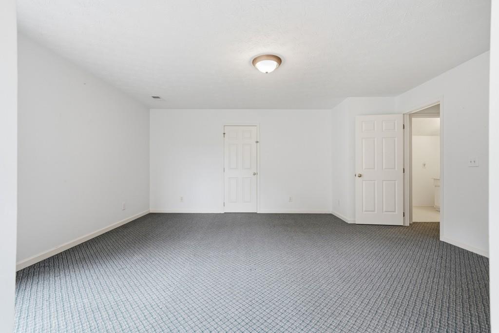 176 Big Oak Tree Road Northwest Adairsville, GA 30103 - Photo 36 of 77 a view of an empty room with wooden floor