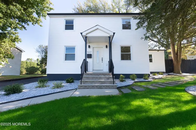 a front view of a house with garden