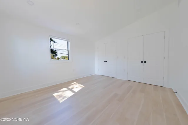 a bedroom with furniture and wooden floor