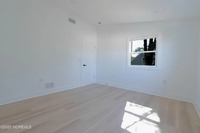 a bedroom with a bed and a night stand