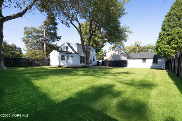 a view of a house with a yard and garage