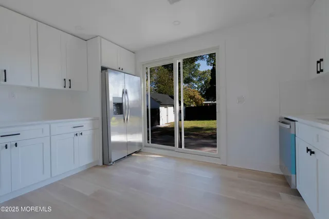 an empty room with sliding door and wooden floor