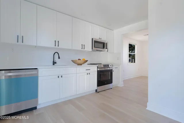 a kitchen with a sink and a stove top oven