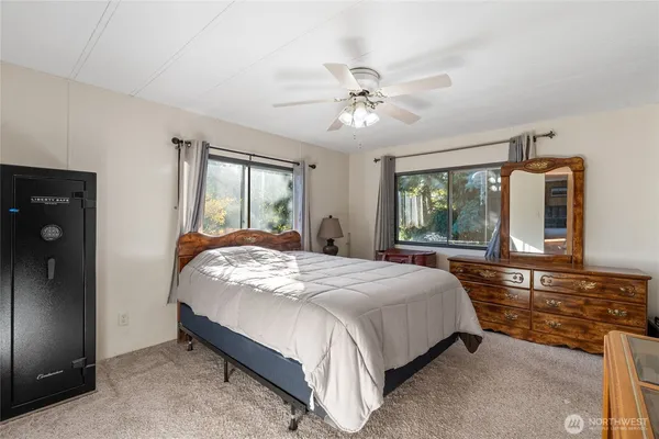 a bedroom with a large bed and a large window