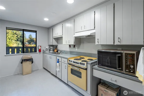 a kitchen with granite countertop a stove top oven