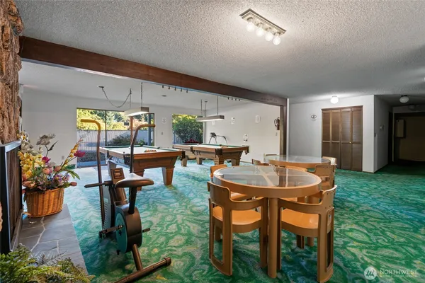 a dining room with chairs and view of kitchen