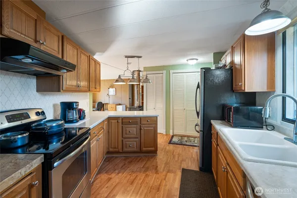 a kitchen with a sink stove and refrigerator
