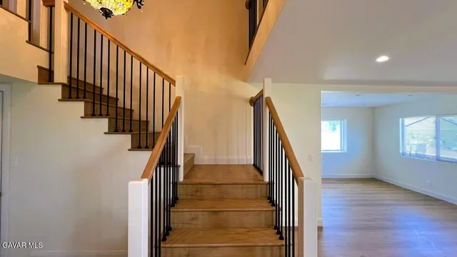 a view of entryway with wooden floor and stairs