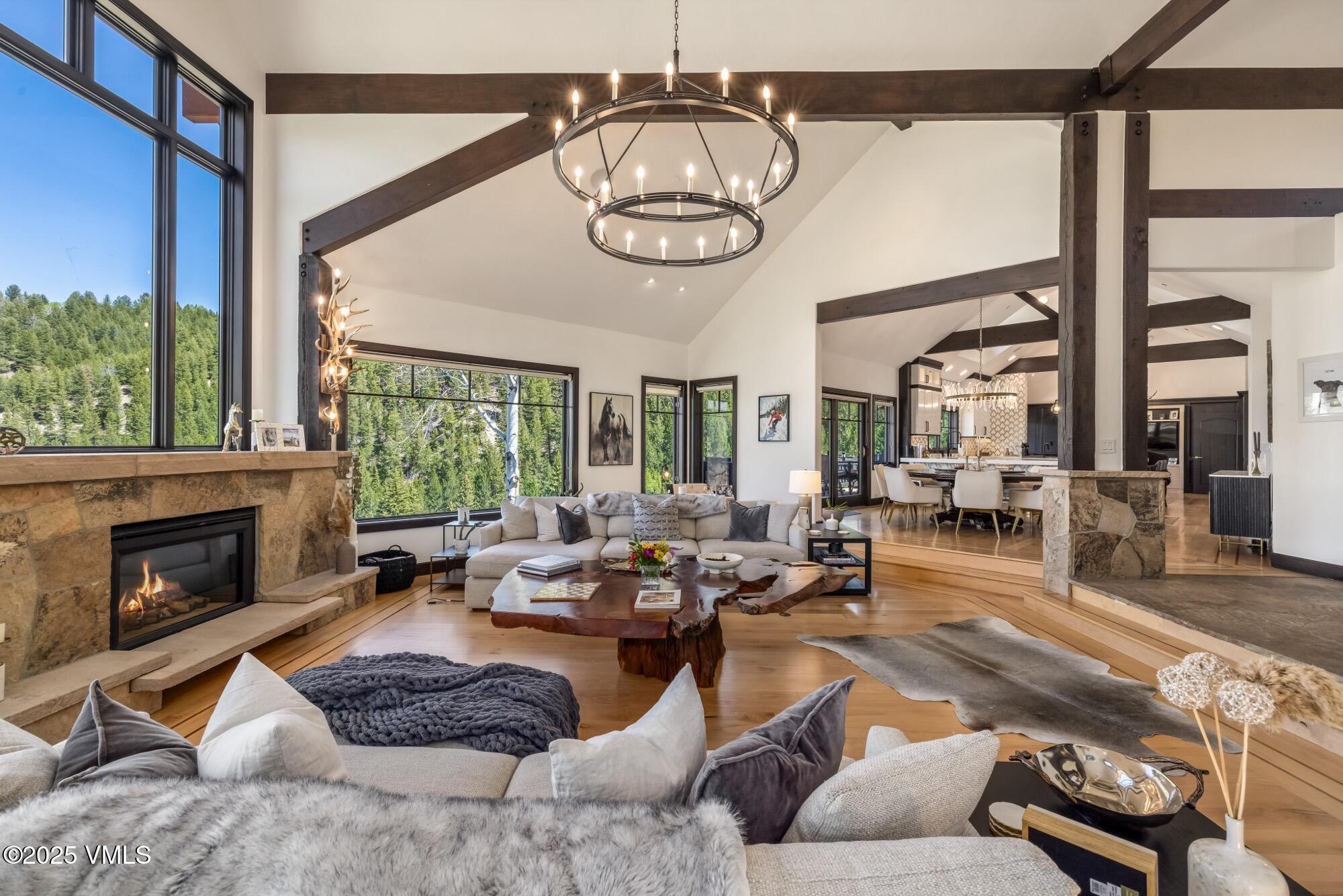 a living room with furniture fireplace and a large window