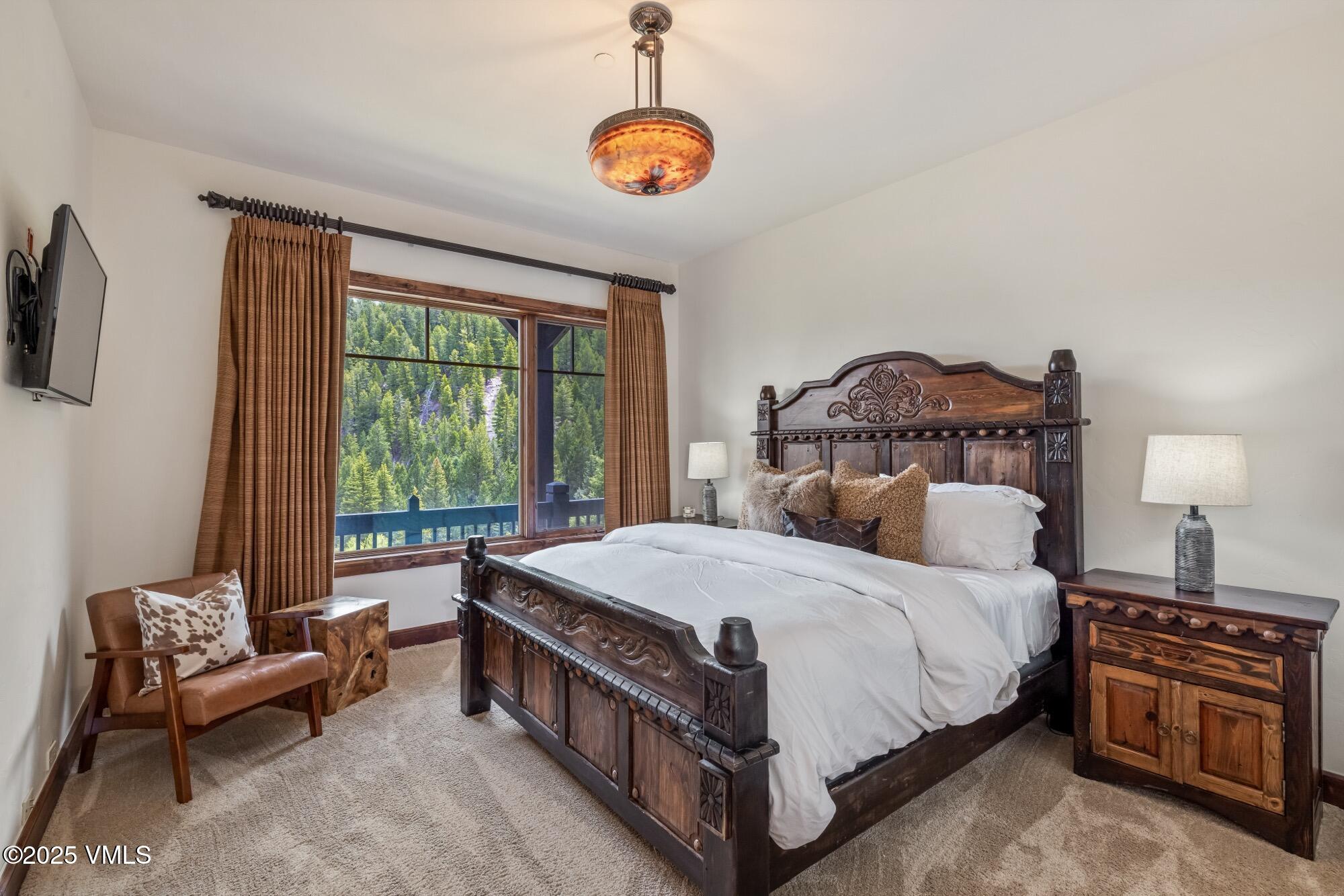 1122 Red Draw Edwards, CO 81632 - Photo 41 of 54 a bedroom with a bed a chandelier and dresser