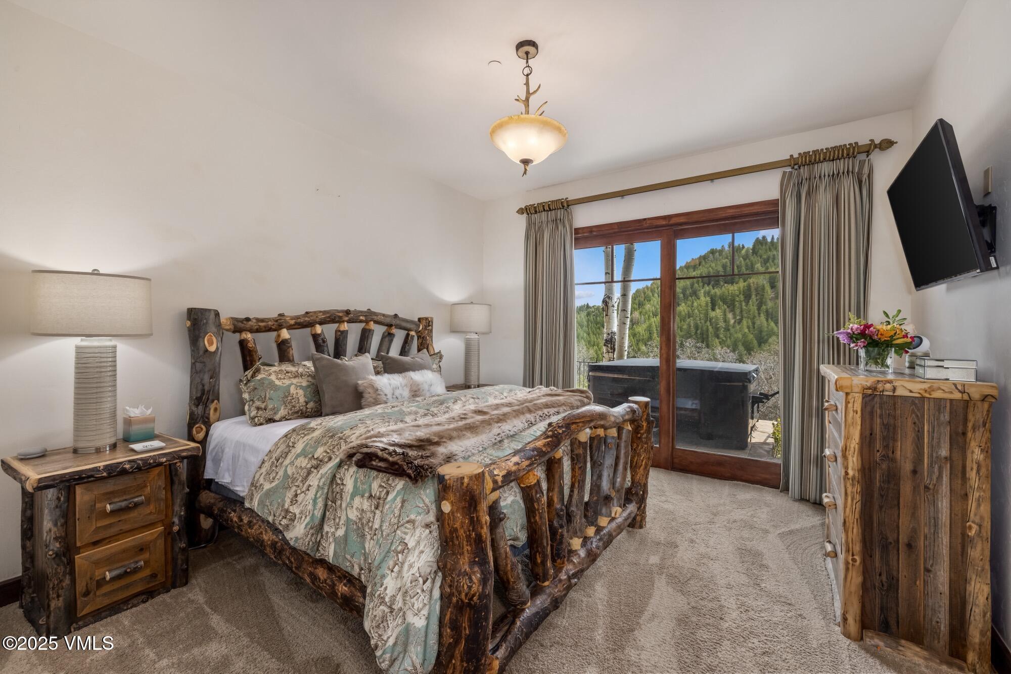 1122 Red Draw Edwards, CO 81632 - Photo 45 of 54 a bedroom with a bed and a flat tv screen on dresser