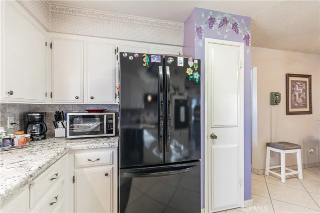 a kitchen with stainless steel appliances a refrigerator and cabinets