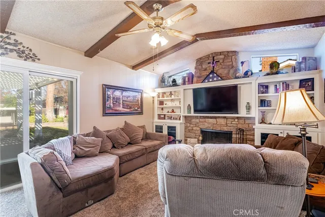a living room with fireplace furniture and a flat screen tv