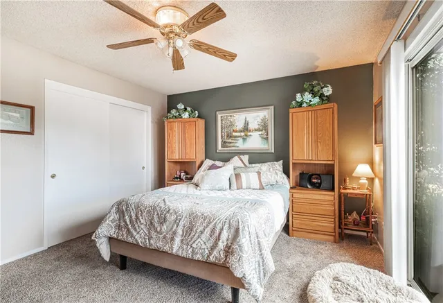 a bedroom with a bed couch and window