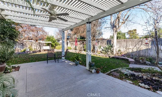 a view of a backyard with plants and outdoor seating