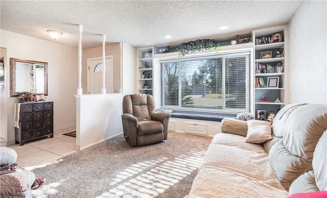 a bedroom with furniture and large windows