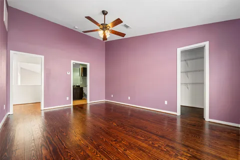 a view of a livingroom with a ceiling fan and wooden floor