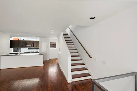 a view of kitchen with sink and refrigerator