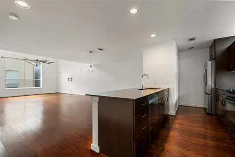 a kitchen with granite countertop a stove and a refrigerator
