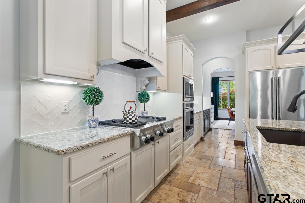 2907 Stewart Way Tyler, TX 75709 - Photo 11 of 45 a kitchen with stainless steel appliances granite countertop a stove a sink and a refrigerator