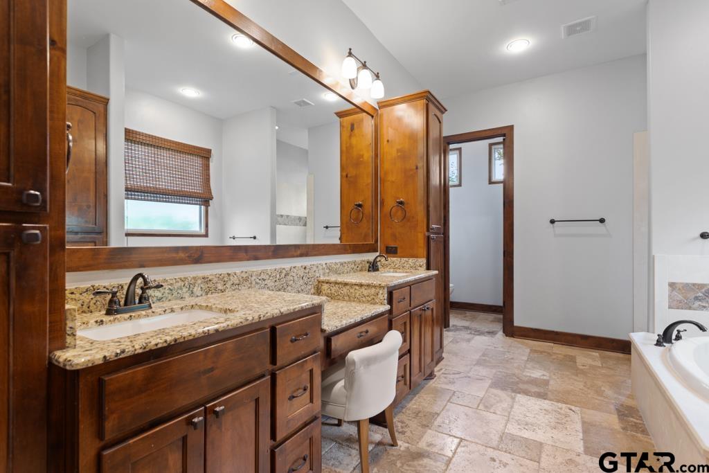 2907 Stewart Way Tyler, TX 75709 - Photo 19 of 45 a bathroom with a sink and a mirror