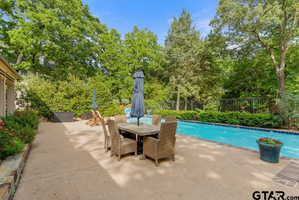 2907 Stewart Way Tyler, TX 75709 - Photo 36 of 45 a view of a patio with table and chairs potted plants with wooden fence