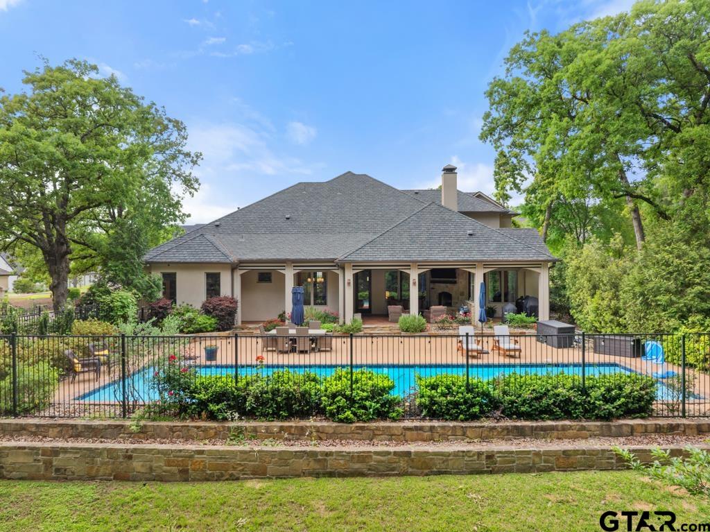 2907 Stewart Way Tyler, TX 75709 - Photo 37 of 45 a front view of a house with a garden and plants