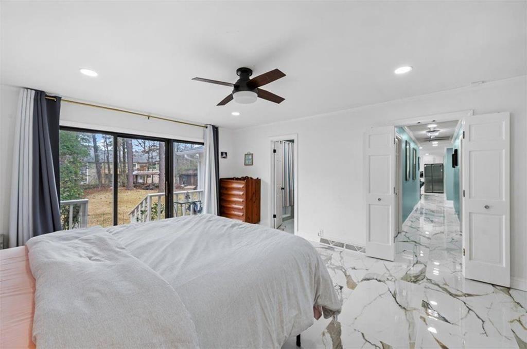 14 Westwood Circle Southwest Rome, GA 30165 - Photo 29 of 53 a large bedroom with a large bed and a chandelier
