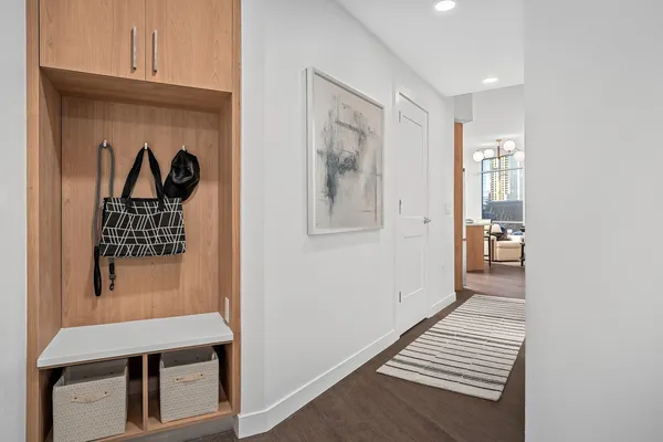 a view of entryway and hall with wooden floor