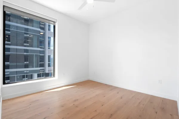 a hallway with white walls and wooden floor