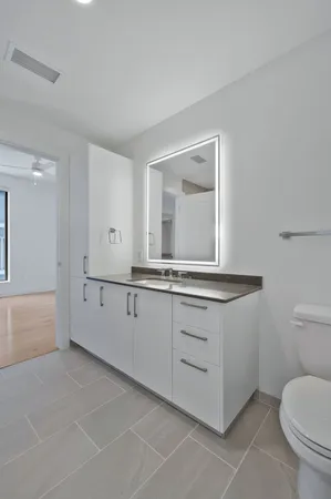 a view of kitchen with stainless steel appliances wooden floor and a large window