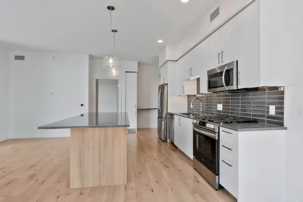 a kitchen with stainless steel appliances granite countertop a stove and a refrigerator
