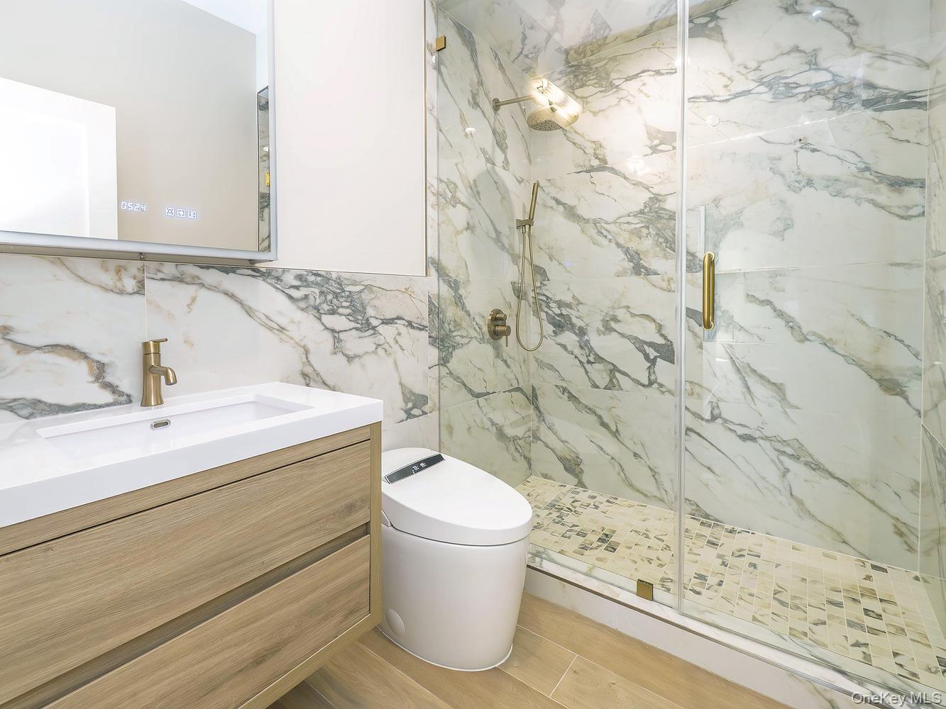 24 Lumber Road, Unit 2 Roslyn, NY 11576 - Photo 19 of 25 a bathroom with a sink and a toilet