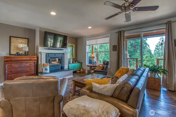 a living room with furniture fireplace and a large window