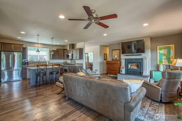 a living room with furniture kitchen view and a fireplace