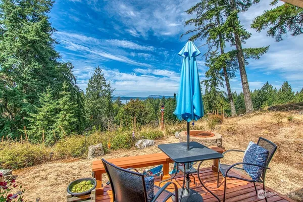 a backyard of a house with table and chairs