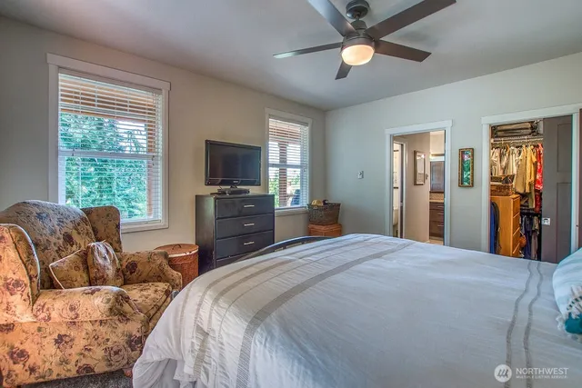 a bed room with a bed and a television