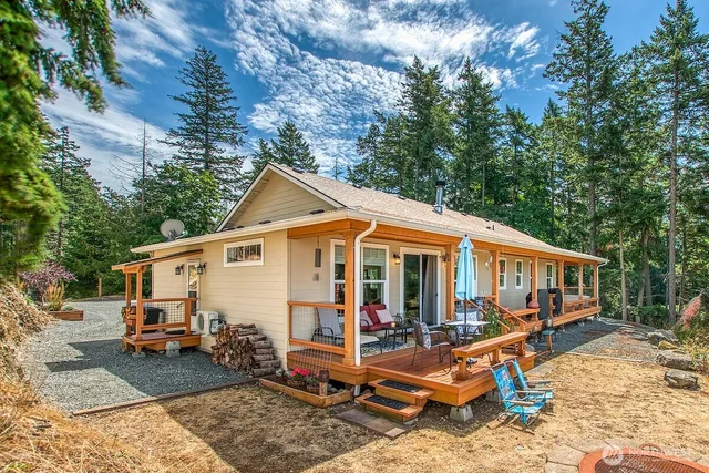 a view of house with yard and sitting area