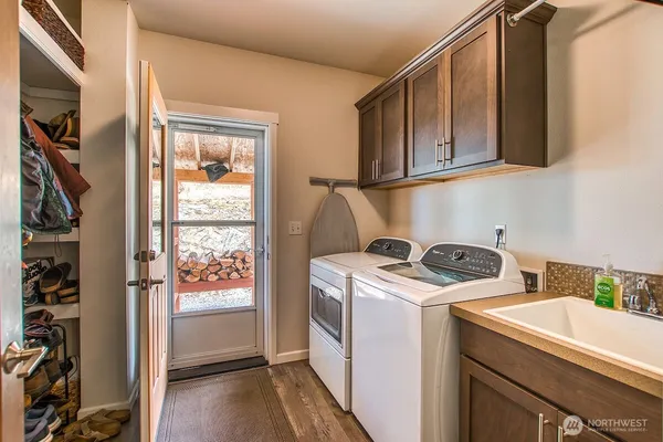 a utility room with dryer washer and a window