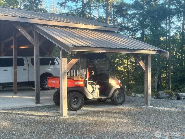 a view of a yard with wooden fence