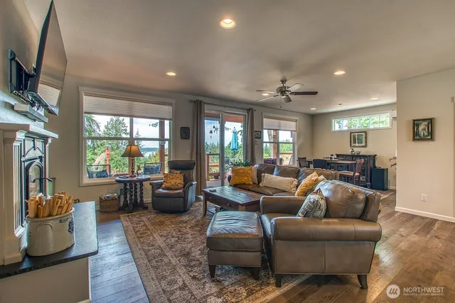 a living room with furniture fireplace and a large window