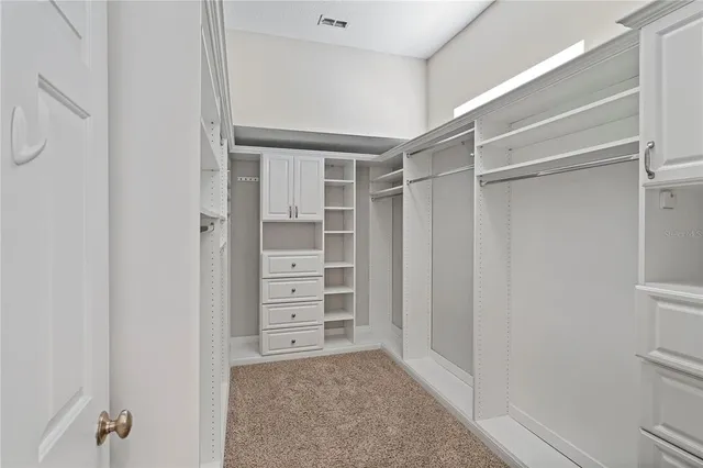 a view of walk in closet with empty racks